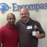 Encompass Warehouse Manager Fuji Ramanan (left) presents a Supplier of the Year Award to Armor Packaging Rep Brian Jarvis